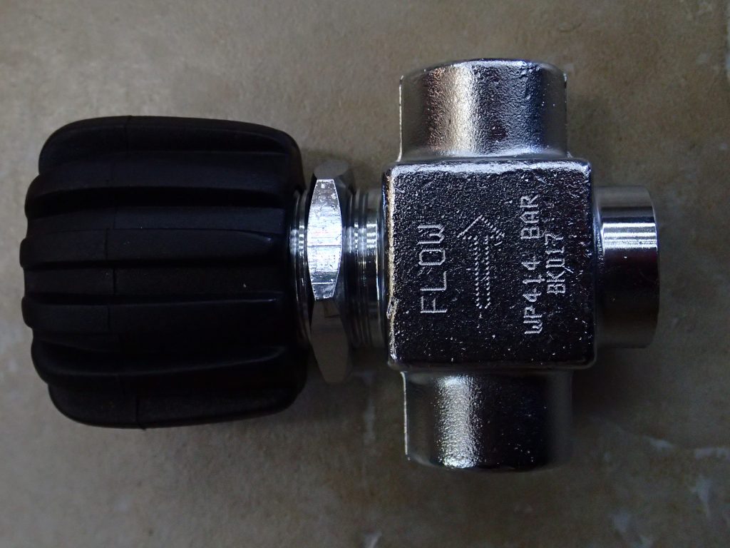 Closeup of silver high pressure air valve with black top